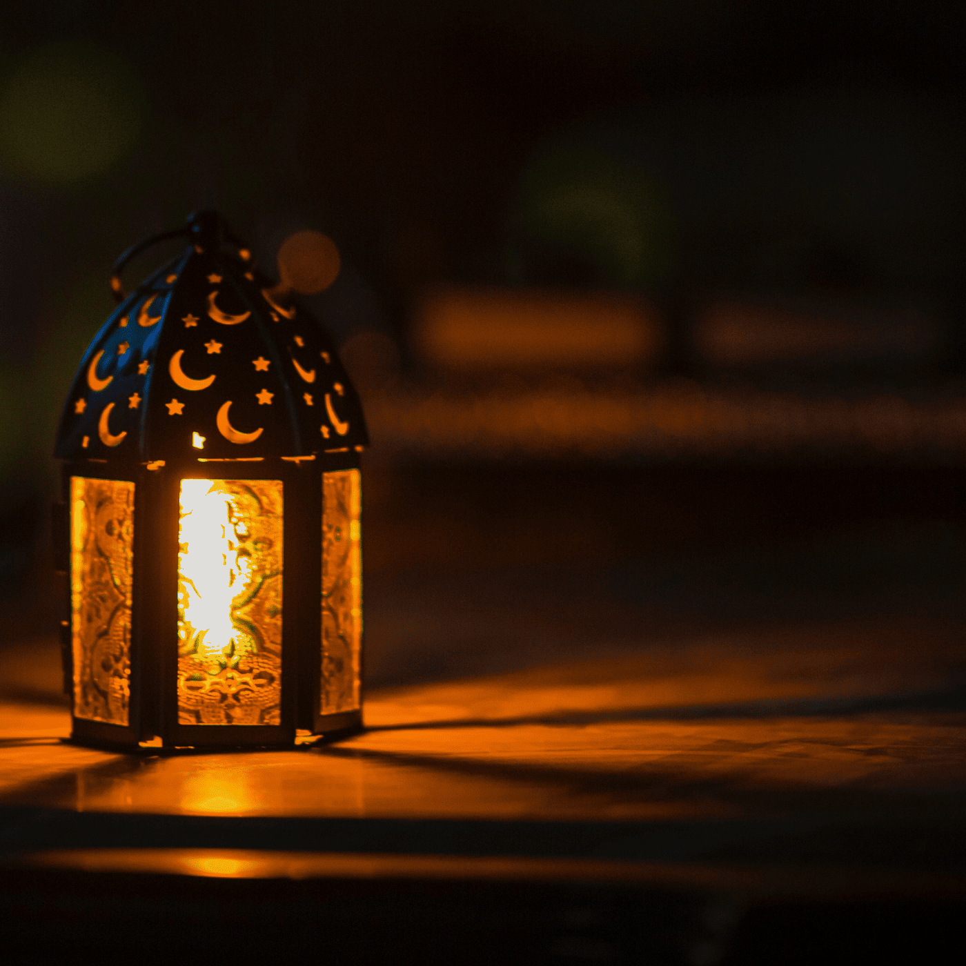 Lit lantern in darkness for Ramadan