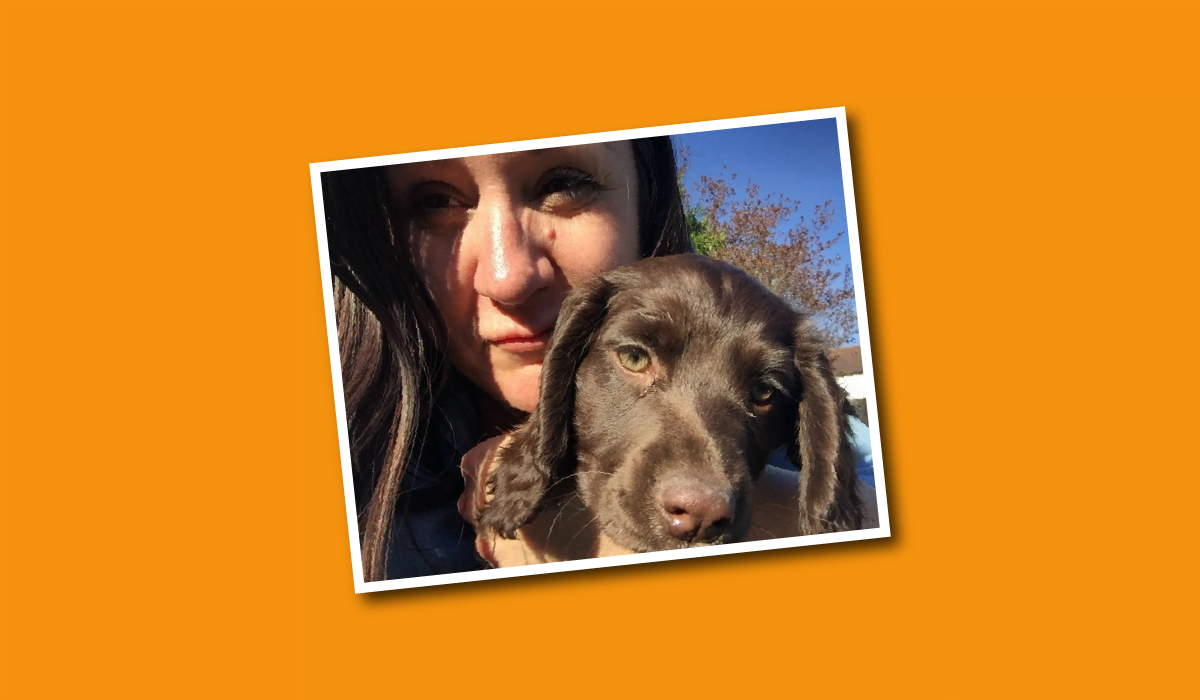 Stephanie Bright, Compliance Manager at TLS, holding her chocolate cockapoo